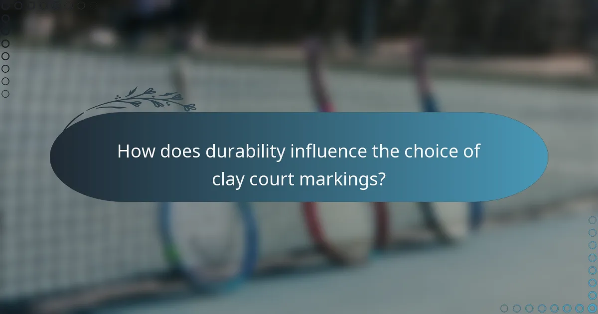 How does durability influence the choice of clay court markings?
